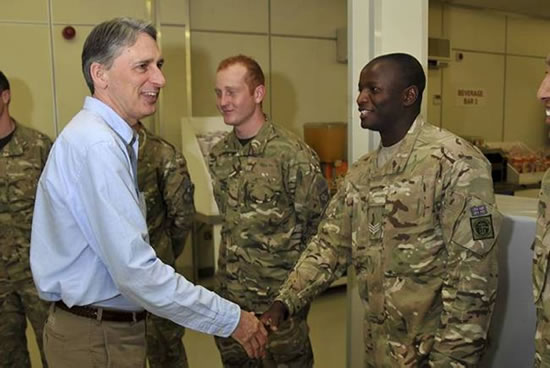 Image show Sergeant Chapwanya of the 8th Regiment, 64 Squadron, Royal Logistic Corps, meeting Secretary of State for Defence Philip Hammond MP at Dining Facility 1, Camp Bastion on the 28 Mar 2012. Photo: Corporal Andy Reddy/MoD
