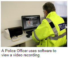A Police Officer uses software to view a video recording