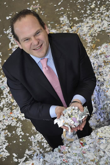 Anthony Pearlgood displaying shredded papers. “Shred it professionally,” he seems to be saying.