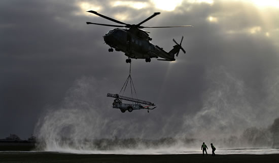 A Merlin helicopter comes in to drop off a Remover 3.1 mast during a snowy morning - Best Single Photograph Depicting the RAF Operational Experience Picture:MoD/ Senior Aircraftman David Turnbull.